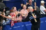 Gold medallist Italy's Nicolo Martinenghi celebrates with fans after the men's 100m breaststroke swimming event during the Paris 2024 Olympic Games at the Paris La Defense Arena in Nanterre, west of Paris, on July 28, 2024. (Photo by Jonathan NACKSTRAND /