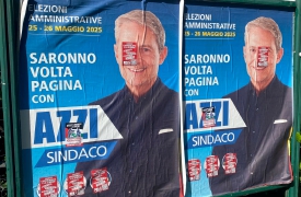 Saronno, adesivi sui manifesti di Azzi