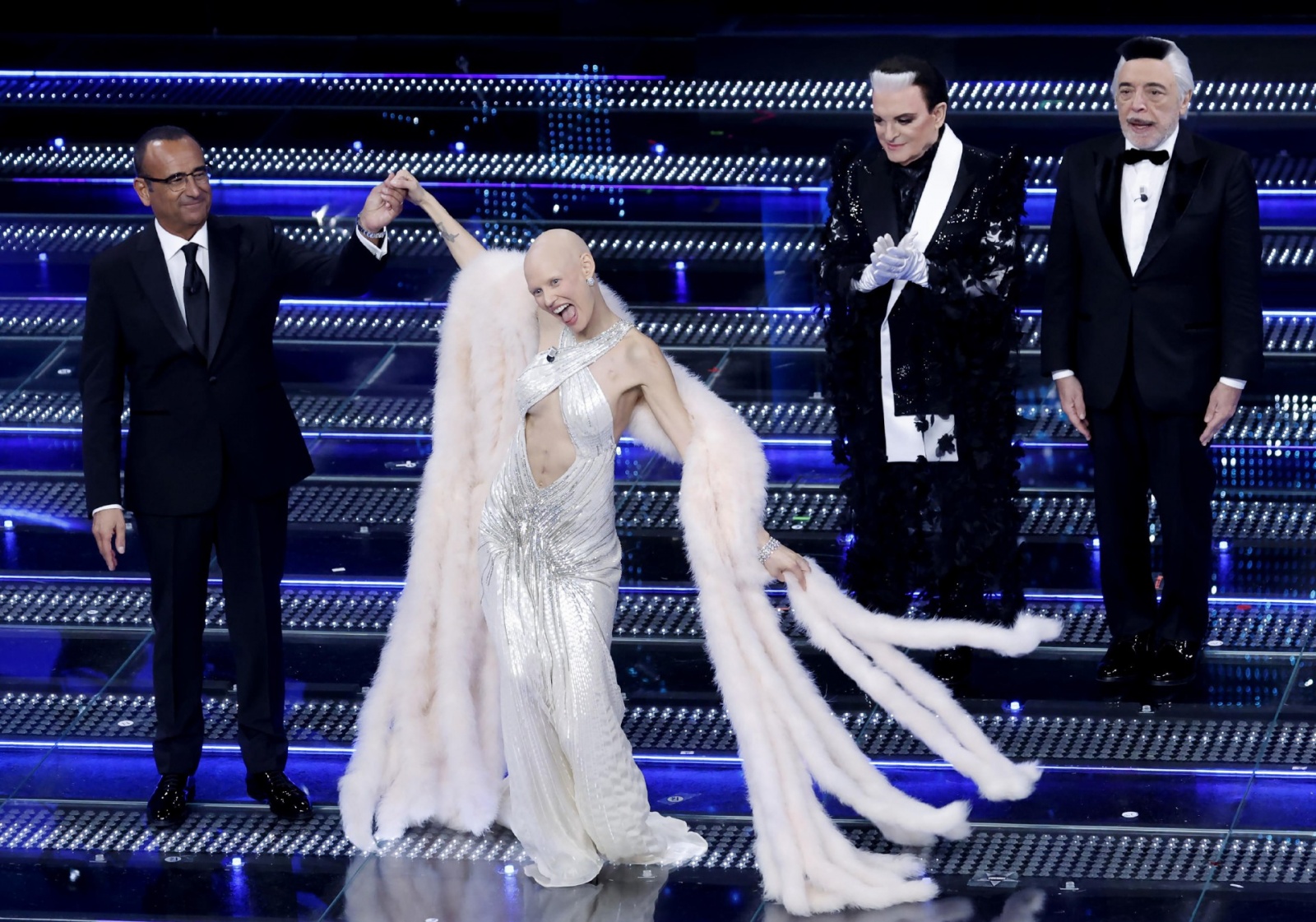 (L-R) Sanremo Festival host and artistic director Carlo Conti, Italian model Bianca Balti, Tv personality Cristiano Malgioglio and Italian actor Nino Frassica on stage at the Ariston theatre during the 75th edition of the Sanremo Italian Song Festival, in