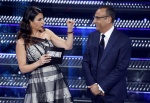 Italian actor Geppi Cucciari (L) and Sanremo Festival host and artistic director Carlo Conti on stage at the Ariston theatre during the 75th edition of the Sanremo Italian Song Festival, in Sanremo, Italy, 14 February 2025. The music festival will run fro