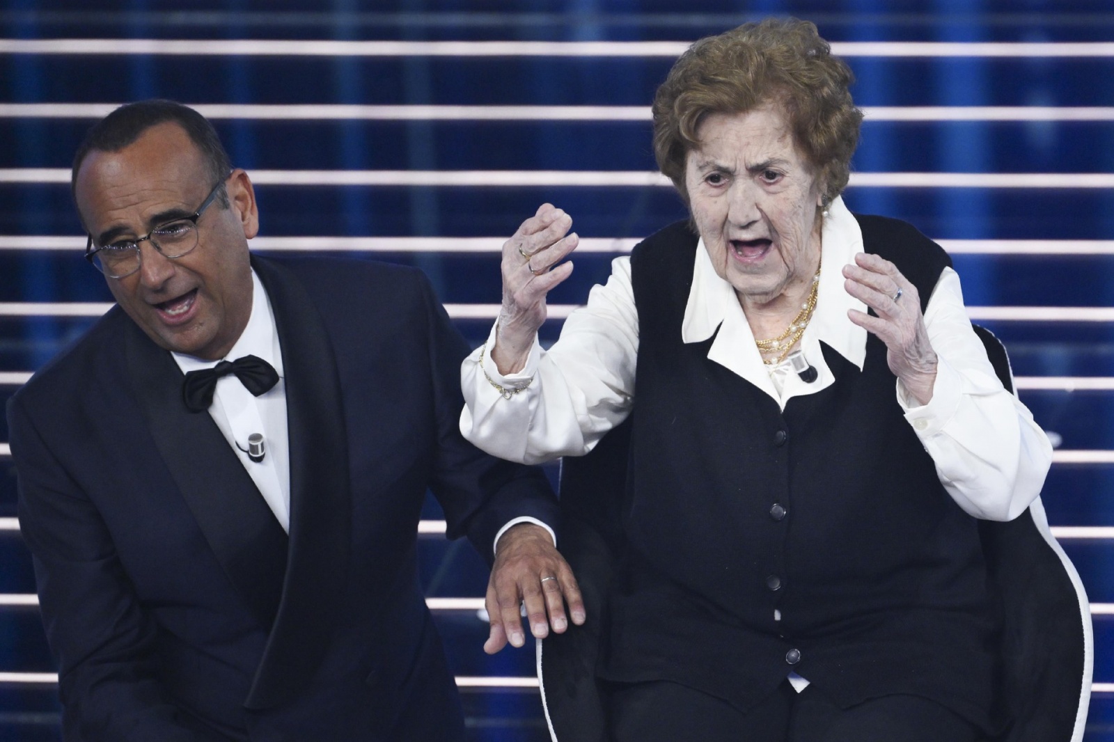 Sanremo Festival host and artistic director Carlo Conti (L) with The 105 year old Italian woman Gianna Pratesi (R) on stage at the Ariston theatre during the 76th edition of the Sanremo Italian Song Festival, in Sanremo, Italy, 24 February 2026. The music