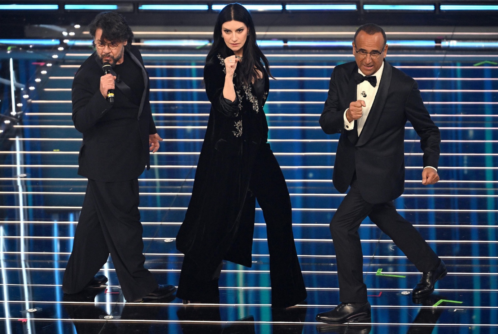Sanremo Festival host and artistic director Carlo Conti (R), Italian singer Laura Pausini (C) and Italian actor Lillo Petrolo on stage at the Ariston theatre during the 76th edition of the Sanremo Italian Song Festival, in Sanremo, Italy, 25 February 2026