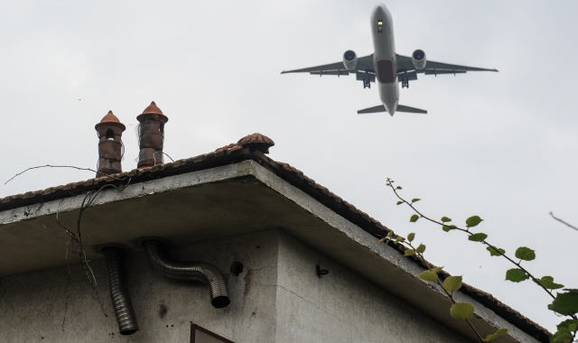 Un aereo sorvola le case nelle vicinanze dell’aeroporto di Malpensa